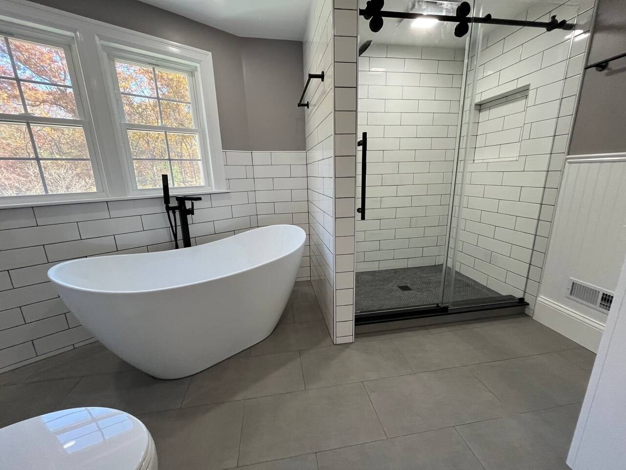Dedham 2024 bath with a freestanding tub and a walk-in shower with glass door