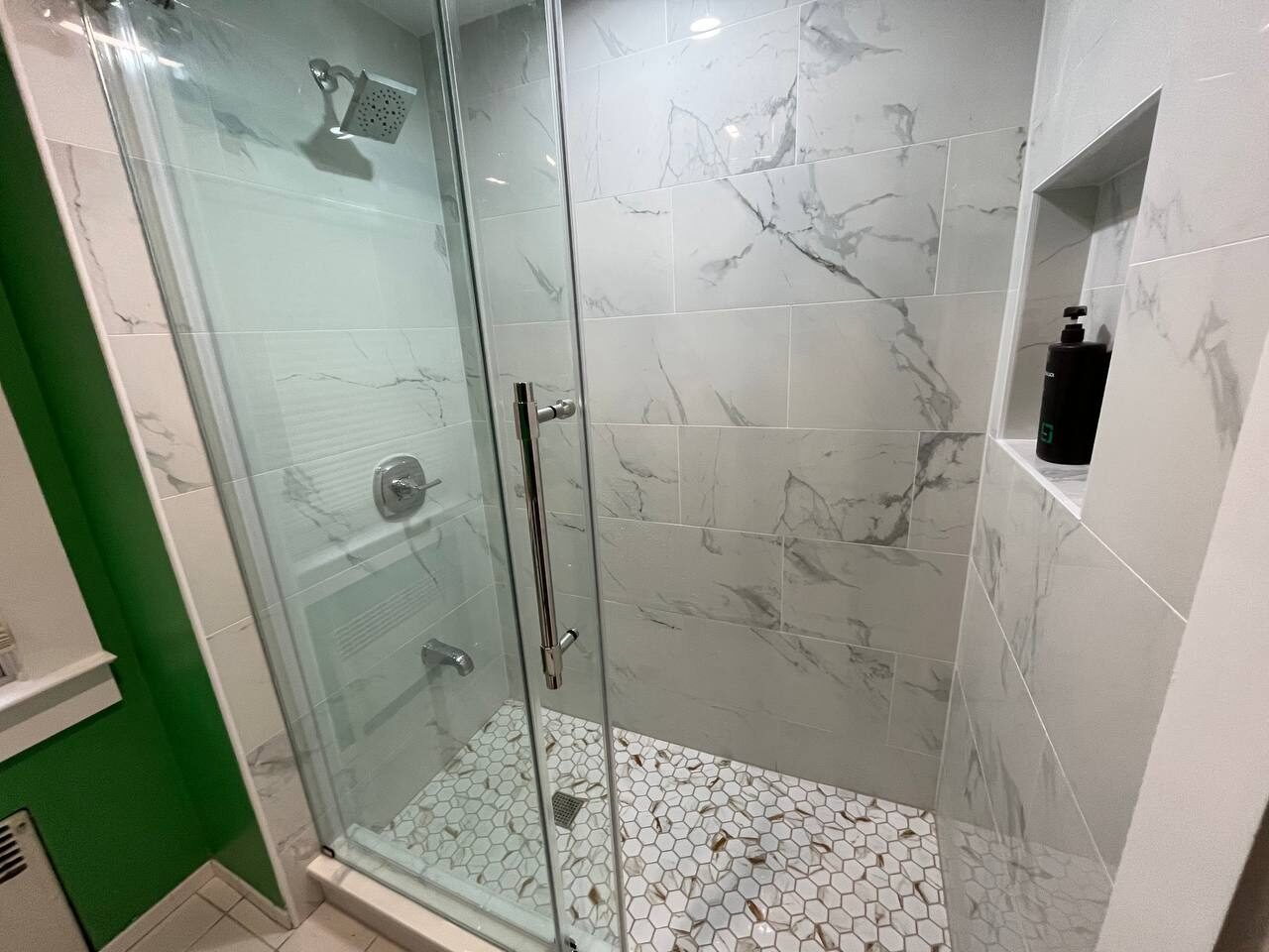 Wellesley 2023 walk-in shower with sliding glass door and niche