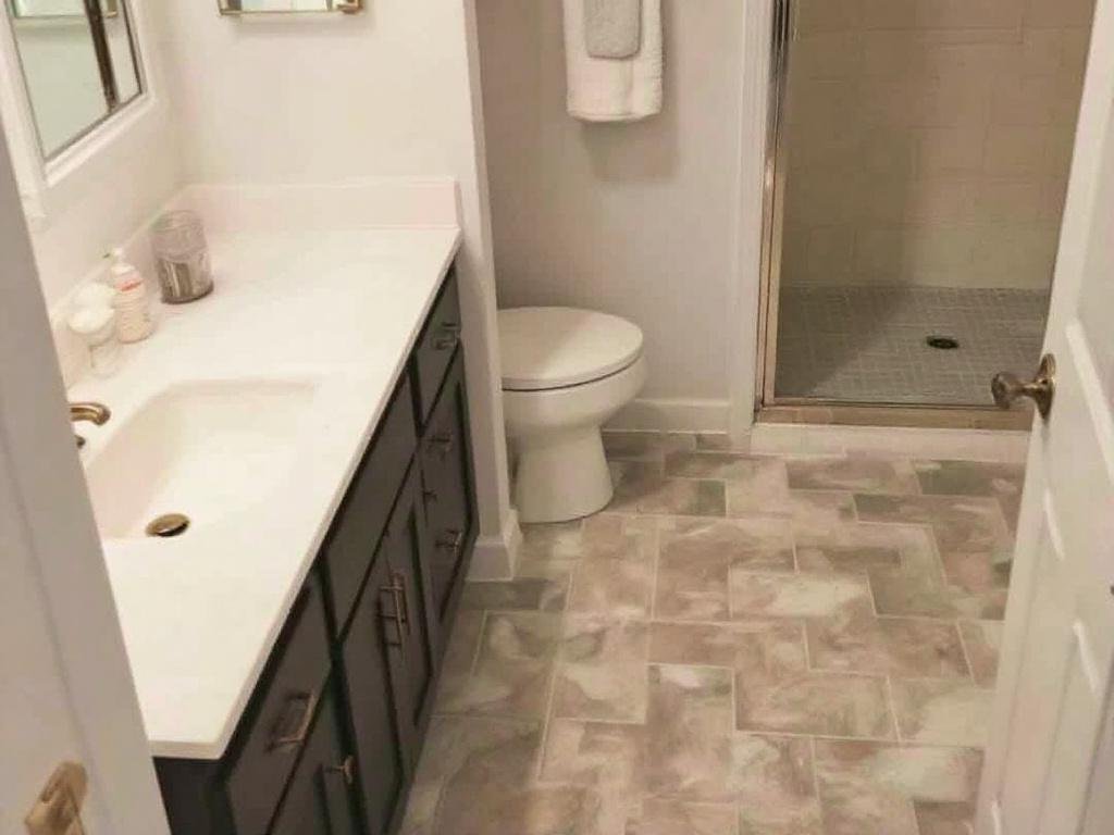 Alt Text: Professional tile flooring installers at work in Winchester, MA.