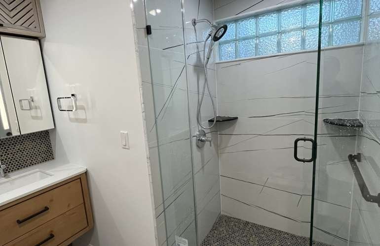 Newton MA master bathroom after Sun Shore remodel: modern vanity, walk-in shower, bright lighting