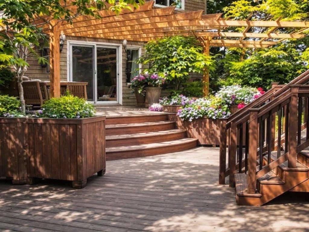 Skilled workers installing a deck in an outdoor space in Woburn, MA.