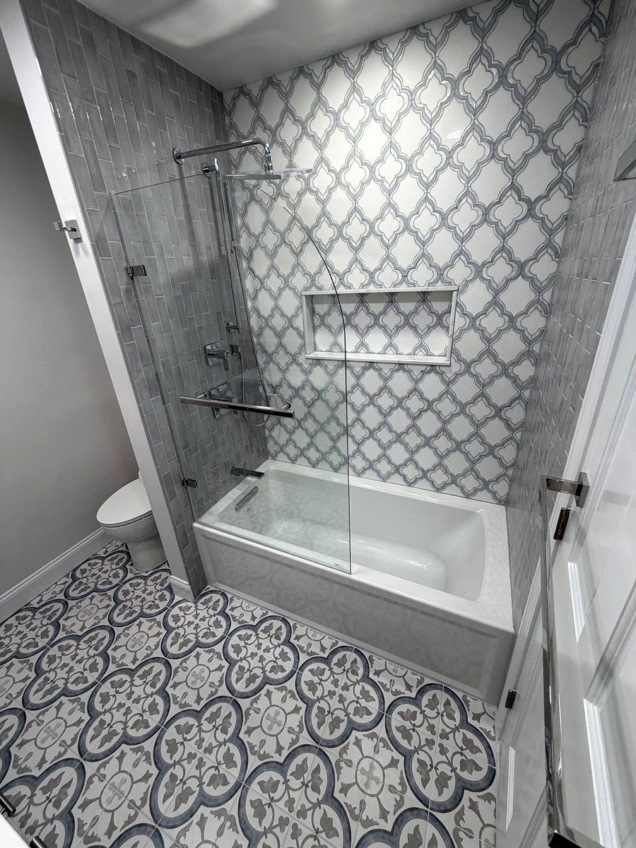 Bathroom renovation Brookline MA - arabesque patterned tile accent wall with bathtub and glass door enclosure