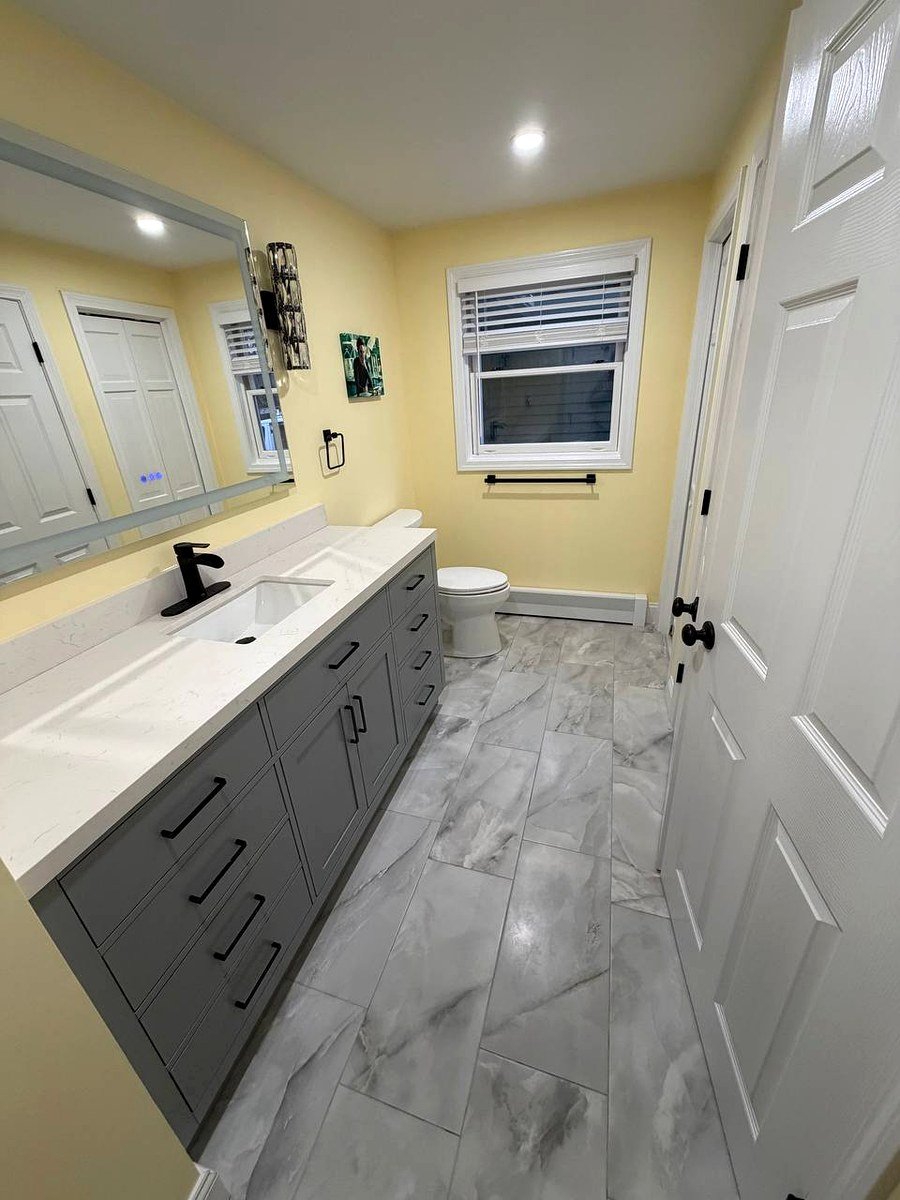 Bathroom renovation Waltham MA - modern vanity with new floor tile and updated fixtures