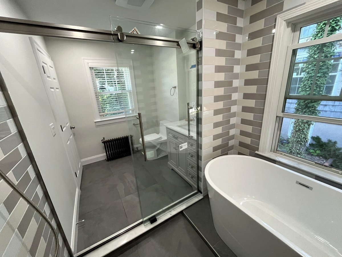 Bathroom renovation Watertown MA - wet room design with freestanding soaking tub and large-format gray floor tile
