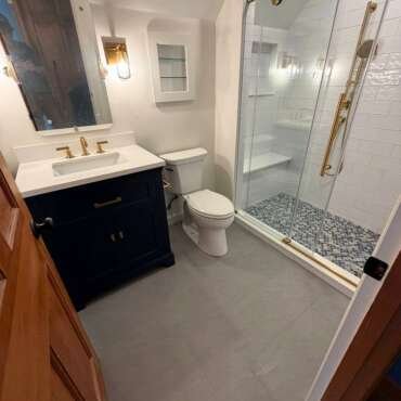 Bathroom Renovation in Westwood, MA | Navy Vanity, Walk-In Shower & Gold Fixtures