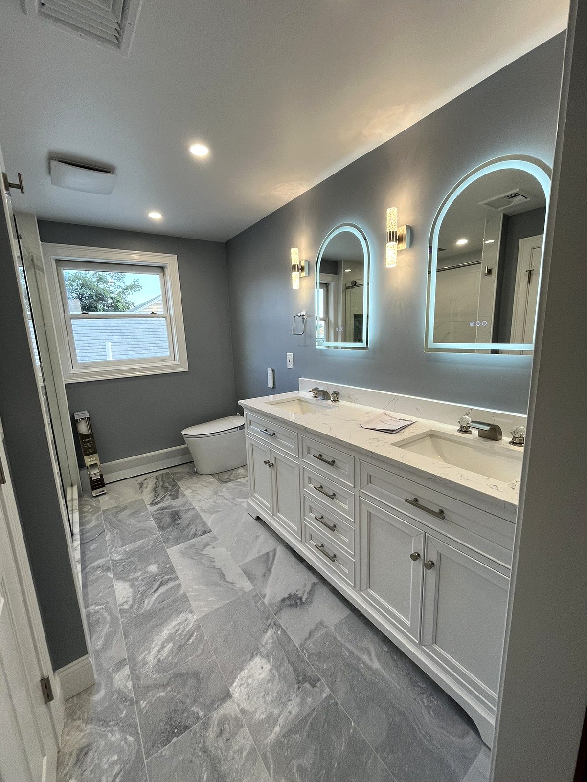Master bath renovation Waltham MA - double vanity with arch LED backlit mirrors and decorative sconces