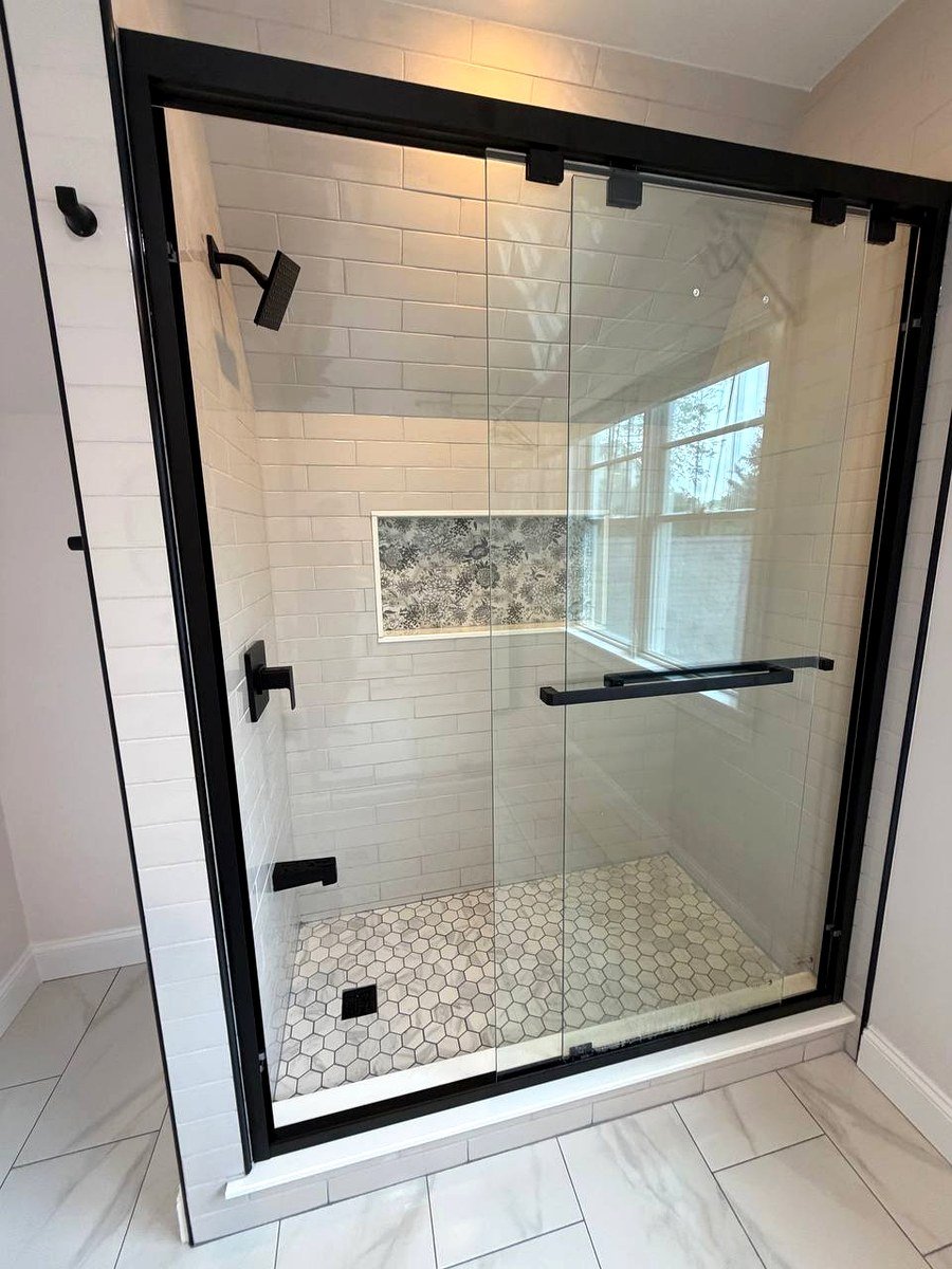 Walk-in shower interior Newton Center MA - white wall tiles with decorative niche and hex mosaic floor