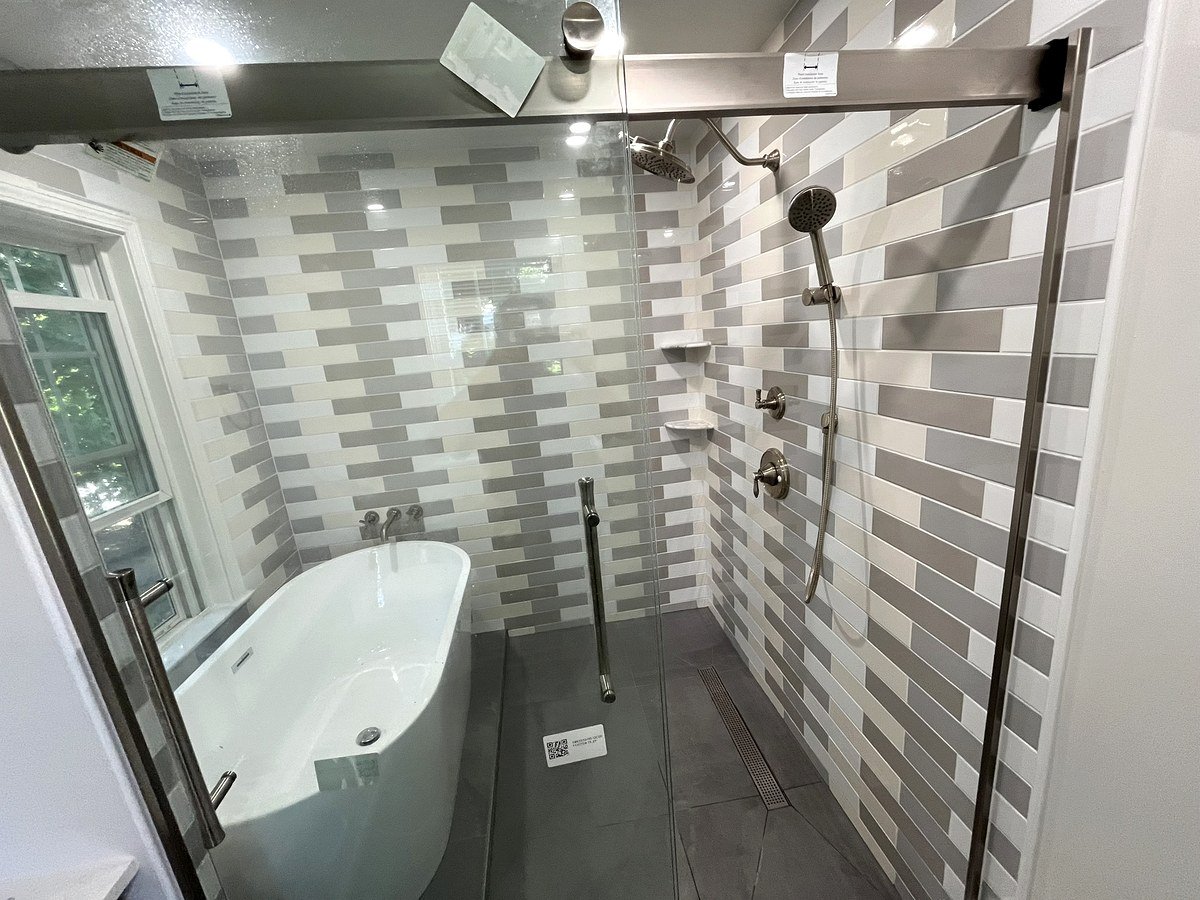 Walk-in shower Watertown MA - freestanding soaking tub inside shower enclosure with horizontal gray tile