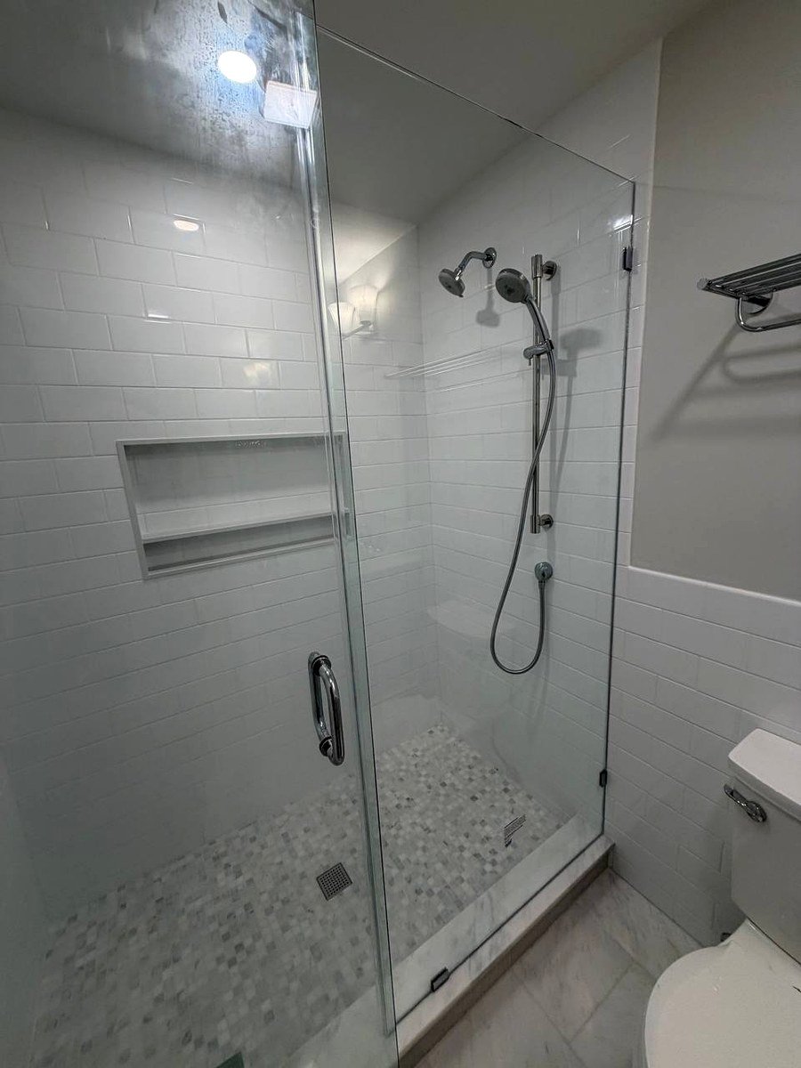 Walk-in shower Weston MA - frameless glass door, white subway tile walls, penny mosaic shower floor