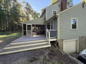 acton-ma-trex-deck-side-view-with-railing Side view of composite deck with white and black railing, Acton MA