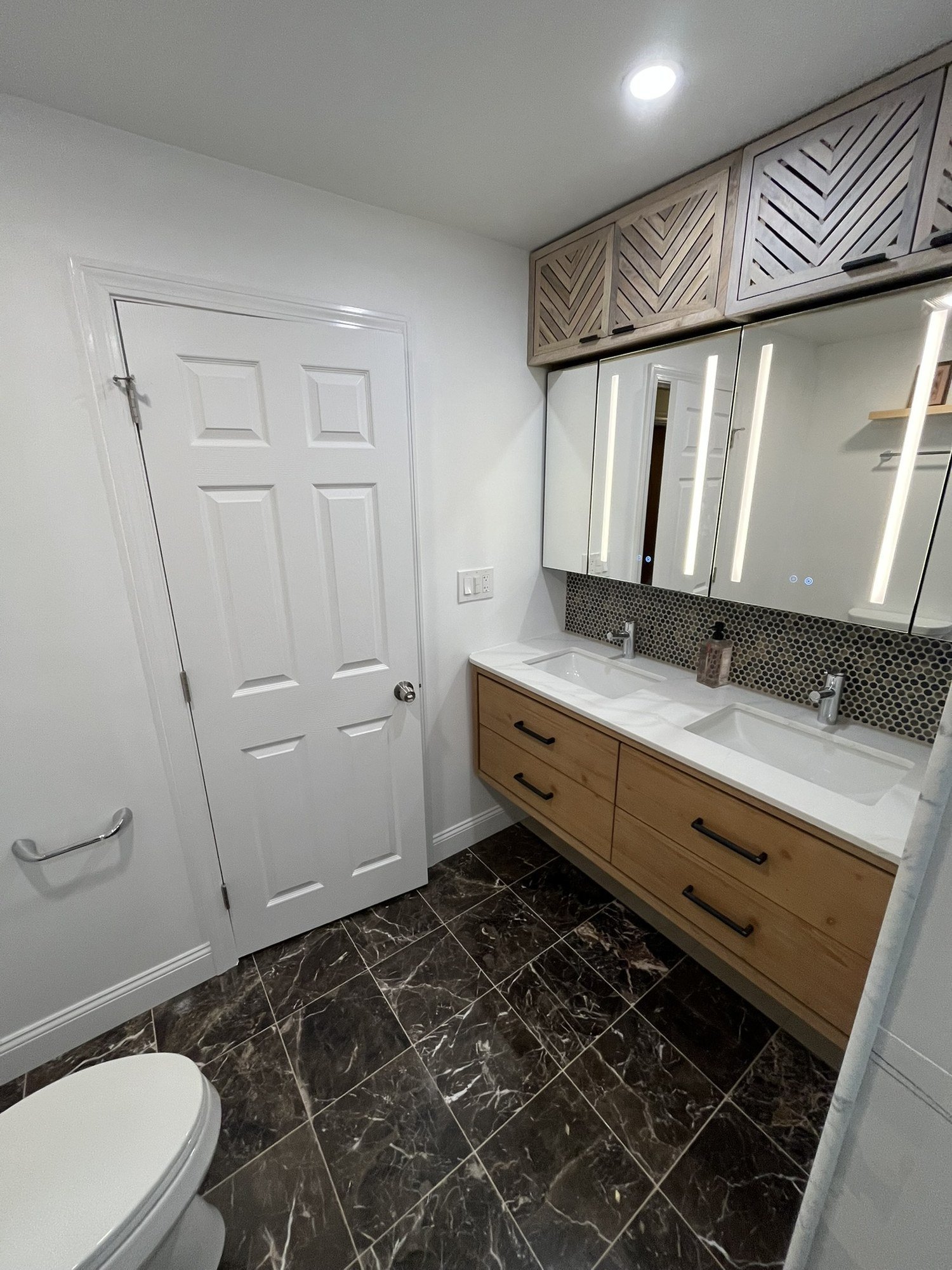 Floating wood vanity with lighted medicine cabinets