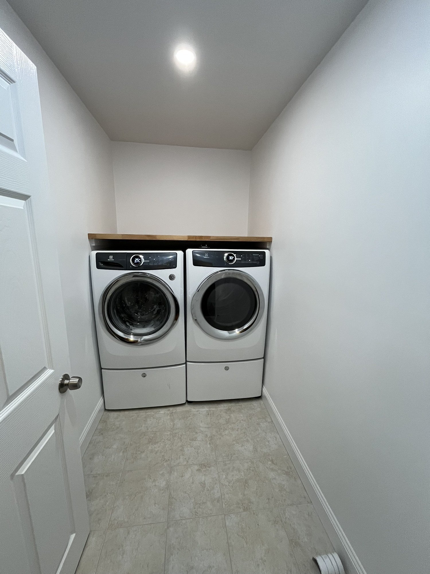 Laundry area with washer and dryer under a countertop